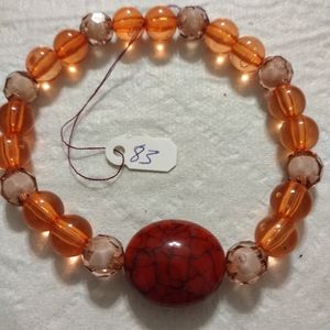 Artemis's Gems custom-made beaded bracelet with large red cracked stone gem
